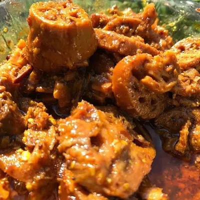 A close-up of my Lotus Stem (Bhen) pickle. The unique, lace-like pattern of the lotus stem makes this pickle as beautiful as it is delicious, with a satisfying crunch.