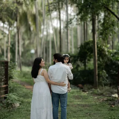 A family's journey is a story told one step at a time. This candid shot captures a family walking together through the woods, a simple moment that speaks volumes about their bond. It’s not about looking at the camera, but about being present with each other.