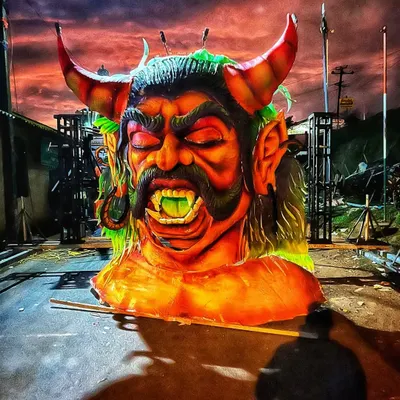 This massive sculpture of a demon head was part of an award-winning tableau for the Madikeri Dasara festival. The dramatic lighting and intense colors made it a highlight of the procession.