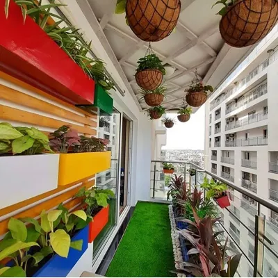 This is a perfect example of a vibrant, modern balcony garden. We used a mix of colorful wall-mounted planters and hanging baskets to create a lush, green escape with a city view.