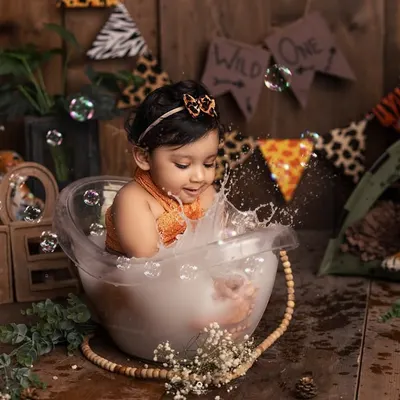 A joyful splash in the tub! This little one is having the time of her life during her jungle-themed bath session. The genuine splashes and giggles make for the best photos.