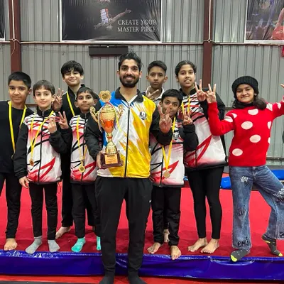 Posing with my team and our trophy after a successful competition. Seeing their proud faces is the greatest reward for a coach.