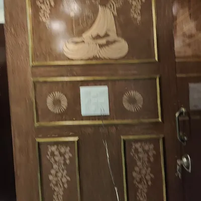 This main door, featuring a beautiful Buddha carving, was carefully polished to enhance its detailed craftsmanship. A quality wood finish not only looks great but also protects the delicate carvings from the elements.