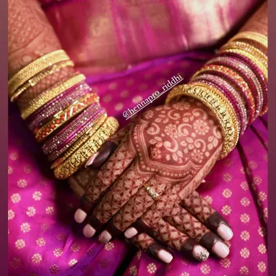 This is the result we aim for. A deep, reddish-brown stain that makes every intricate detail pop. The color looks absolutely stunning against the bride's silk saree and bangles.