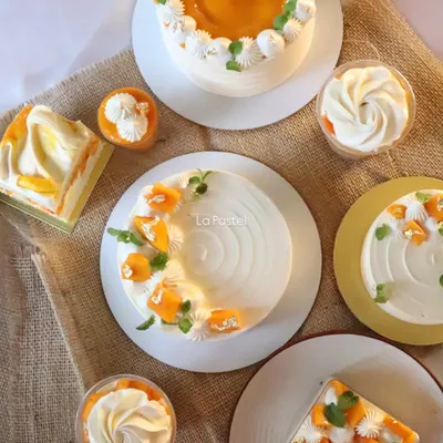 A flat lay of my special mango menu items, including mango cakes, mango tres leches tubs, and mango sundaes.
