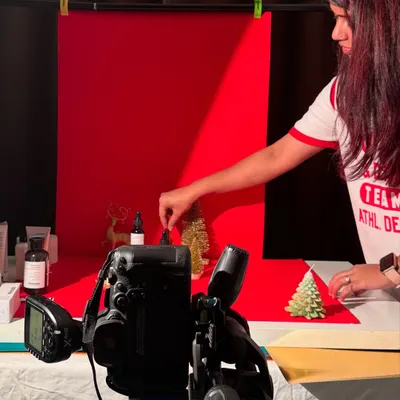 A behind-the-scenes shot of me styling a product shoot with a festive, Christmas theme. This shows the hands-on work that goes into creating the perfect shot.