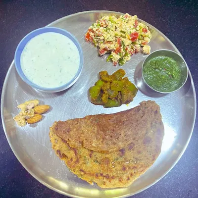 This is my ideal plate for breaking a fast. It features a moong dal and almond flour chila, paneer bhurji, capsicum masala, and cucumber raita. It's packed with protein and healthy fats to nourish the body.
