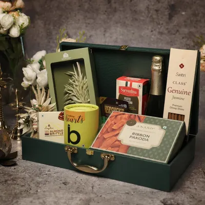 A sophisticated corporate Diwali hamper in a dark green trunk. I teach my students how to balance gourmet food items with non-perishables and elegant decor to create a high-value gift.