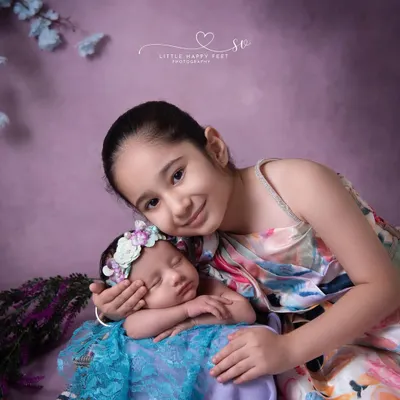 There is nothing sweeter than a big sister's love. Capturing this gentle embrace was a truly special moment, a memory this family will look back on for years to come.