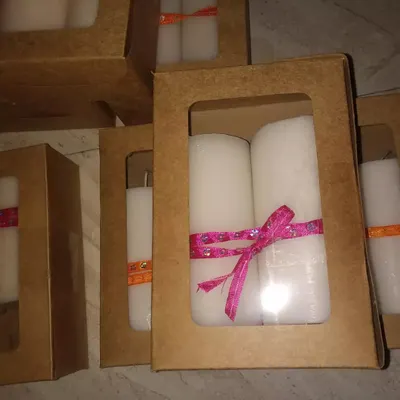 An example of my gift box packaging for pillar candles. These boxes protect the candles and come with decorative ribbons, making them an affordable and attractive gifting option.