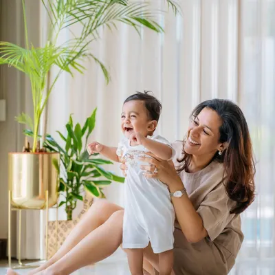 The pure joy on this baby's face says it all! An at-home lifestyle session is perfect for capturing these priceless, natural reactions in a comfortable and familiar environment.