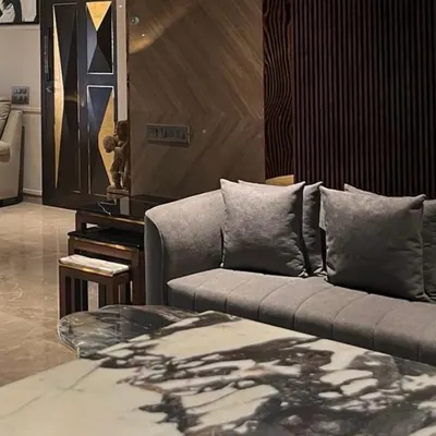 This Juhu apartment is an experience in modern luxury. From the bold geometry of the custom door to the striking marble coffee table, every detail is envisioned to create a dialogue between sophisticated design and a comfortable lifestyle.