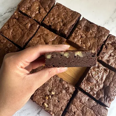 Fudgy, rich, and nutty. My Belgian Chocolate Brownies are now available with walnuts for an extra crunchy bite, as you can see in this cross-section.