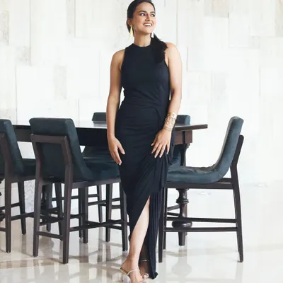 A full-length shot of the elegant black dress I styled for actress Shraddha Srinath's film promotions. The draped fabric and thigh-high slit create a look that is both sophisticated and modern.