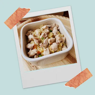 A close-up of our 'Bow Chicky Bow Chow'. This customizable meal features lean chicken, organ meat, fresh vegetables, and brown rice. A grain-free option is also available.