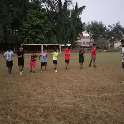 A coach briefing the team before a drill. Clear communication and setting expectations are key to a productive and disciplined training session.