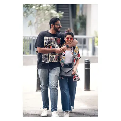 A fun, candid shot of a couple walking down Church Street in Bangalore. Their laughter and casual interaction are what make this urban portrait feel so real and full of life.