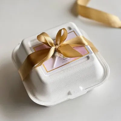 My signature white bento box, elegantly wrapped with a gold satin ribbon. This simple touch turns a delicious cake into a beautiful, ready-to-give present.