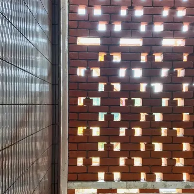 A close-up of the perforated brick screen at our Kolgaon Masterplan project, seen during construction. This image shows how the pattern of the brickwork is designed to filter light and create a dynamic play of shadows.