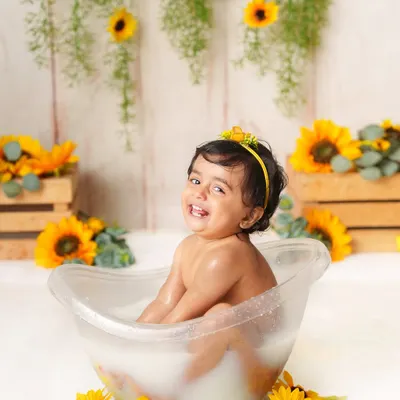 The biggest, happiest smile during a sunflower-themed milk bath session. These splash sessions are all about capturing pure, uninhibited joy.