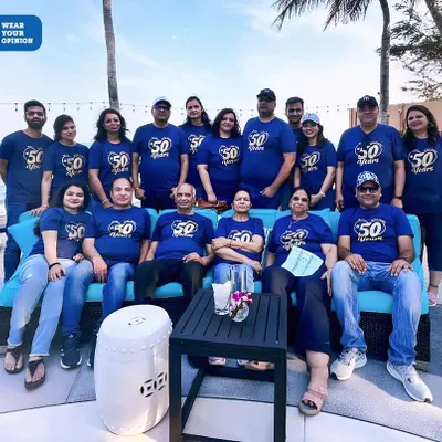 Celebrating a 50th milestone with the entire family. These custom navy blue t-shirts with a "50 Years" print brought the group together for a memorable beachside photo.