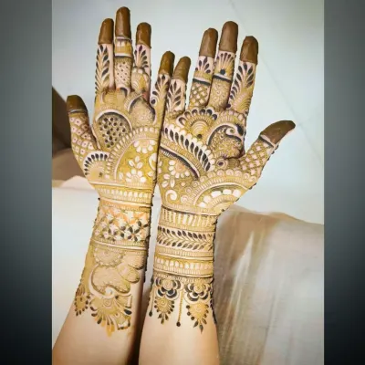 A different angle of a peacock-themed bridal mehandi, showing the details on the fingers and wrist.
