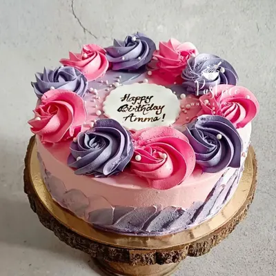 A floral strawberry cake made for a very special mother. The combination of pink and purple buttercream rosettes on a soft, fresh strawberry cake is one of my favorite designs to create.
