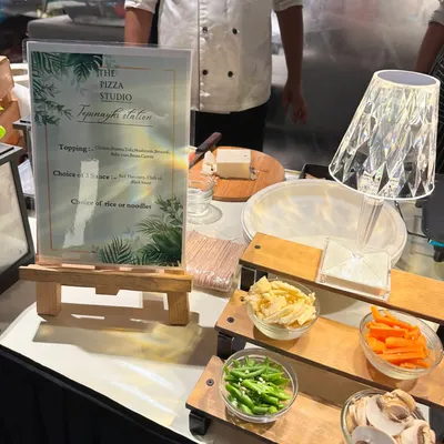 This is a close-up of our live Teppanyaki station. You can see the neatly arranged ingredients like sliced mushrooms, carrots, and beans, ready for our chef to grill them to perfection for your guests.