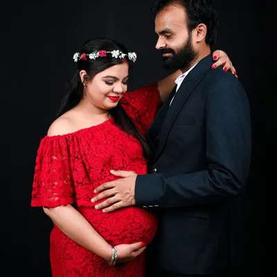 A classic and intimate couple's maternity portrait. The simple black background in my studio really makes the connection between the parents to be stand out.