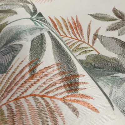 This close-up showcases the artistry of our 'Jardin Ephémère' collection. An artist's hand-drawn sketch is reinterpreted on embroidered linen, with varied stitches reflecting the spontaneous character of a pencil drawing and adding depth to the foliage.
