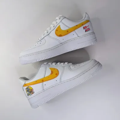 The inner side of the Tom and Jerry AF1s, featuring a cheese-themed swoosh and the "Rat of Air" text for a playful touch.