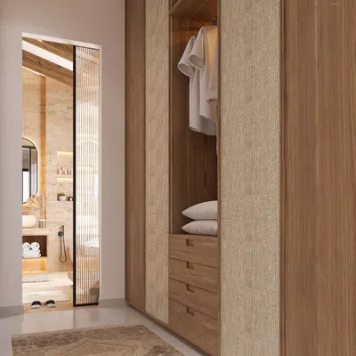 Less clutter, more calm. This walk-in closet features textured fabric and warm wood grain shutters, with a layout that breathes. It's a perfect example of how we design functional spaces that feel like quiet luxuries.