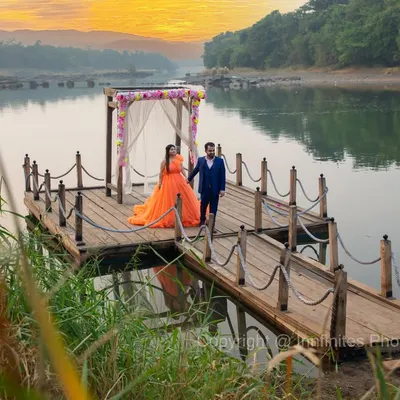 A breathtaking sunrise shoot on a wooden dock by the lake. The warm light and serene water create a truly magical and romantic pre-wedding setting.