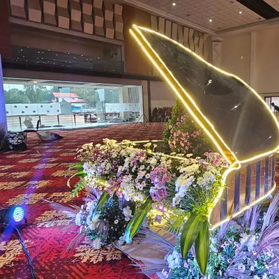 A truly one-of-a-kind decor piece: a grand piano filled with an abundance of fresh flowers and outlined with neon lights. This is the kind of creative statement piece I love to design.
