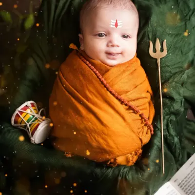 A divine newborn Mahadev, complete with a tripundra on his forehead, a rudraksha necklace, and a tiny trishul. This is one of our most requested spiritual themes.