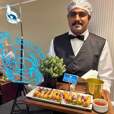 My staff, dressed in professional attire, ready to serve at an event. The glowing Soul Chef neon sign in the background is a symbol of the energy and passion we bring. This image shows our readiness to create a magical experience.