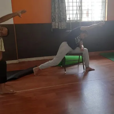 In this chair yoga session, students practice a supported variation of Virabhadrasana (Warrior Pose). Using a chair helps maintain alignment and stability, making powerful poses accessible to people with knee issues or balance concerns.