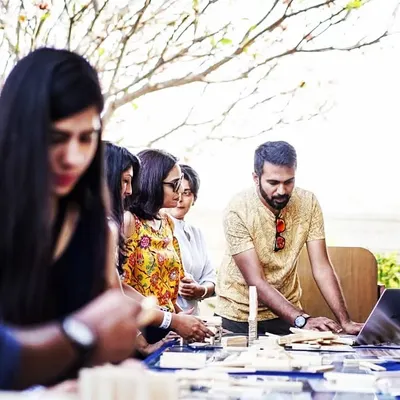 A facilitator guides a team at an outdoor event. We adapt our sessions to fit any environment, providing all the necessary equipment to create an engaging and productive team-building experience for your group.