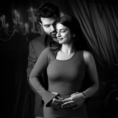 A timeless black and white couple portrait, showcasing our artistic approach to studio photography with dramatic lighting and a focus on emotion.