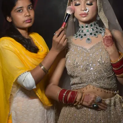 A student from my one-on-one class uses the powder brush to set the makeup on a bridal model. It is essential for students to learn with professional-grade tools.