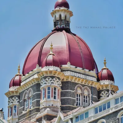 A detailed shot of the iconic red dome of The Taj Mahal Palace hotel, showcasing the intricate design of India's first luxury hotel.