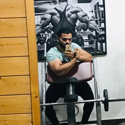 A quick bicep flex after a workout. Progress might be slow sometimes, but consistency is what builds a champion's physique over time.