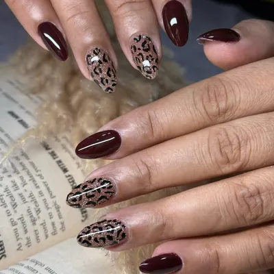 A design that is both wild and elegant, featuring deep brown nails paired with a fierce cheetah print with a glittery glow. This is a show-stopping look for those who want to make a bold statement.