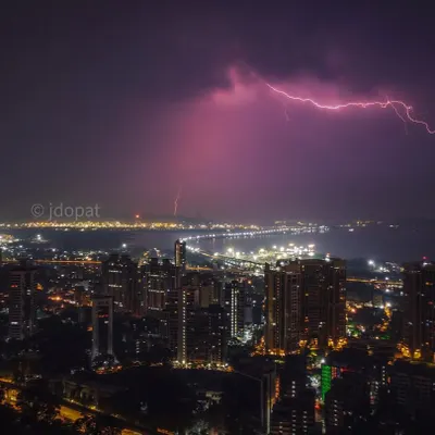 A powerful lightning bolt spreads across the night sky over the Mumbai sea and the Trans Harbour Link, captured with a drone.