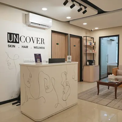 The reception desk at our Lajpat Nagar clinic, featuring our signature line-art aesthetic.
