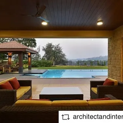 This is an outdoor seating area of a weekend home we designed in the Khandala valley. The covered patio seamlessly connects the indoor living space with the pool and lawn, offering picturesque views and a perfect space for relaxation.