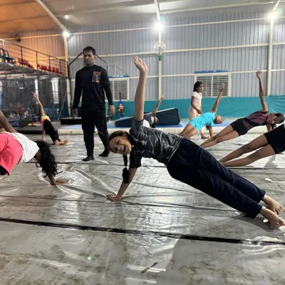 Strong cores make strong gymnasts. Our classes always include conditioning work like these side planks to build the stability required for every apparatus.