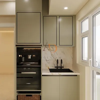 This compact utility area adjacent to the main kitchen houses a built-in coffee machine and oven, showcasing how I maximize functionality with smart vertical storage.
