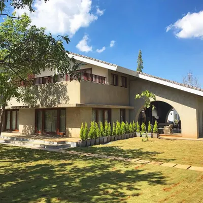 A stunning Khandala holiday home we had the pleasure of landscaping for a renowned film director. The design focused on creating a large, open lawn for relaxation and events, framed by carefully selected trees and shrubs that complement the home's earthy architecture.