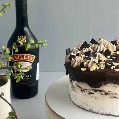 A closer look at my Bailey's Irish Cream cake. You can see the rich chocolate sponge, the light cream, and the silky ganache, all kissed with the smooth, velvety charm of Bailey's.